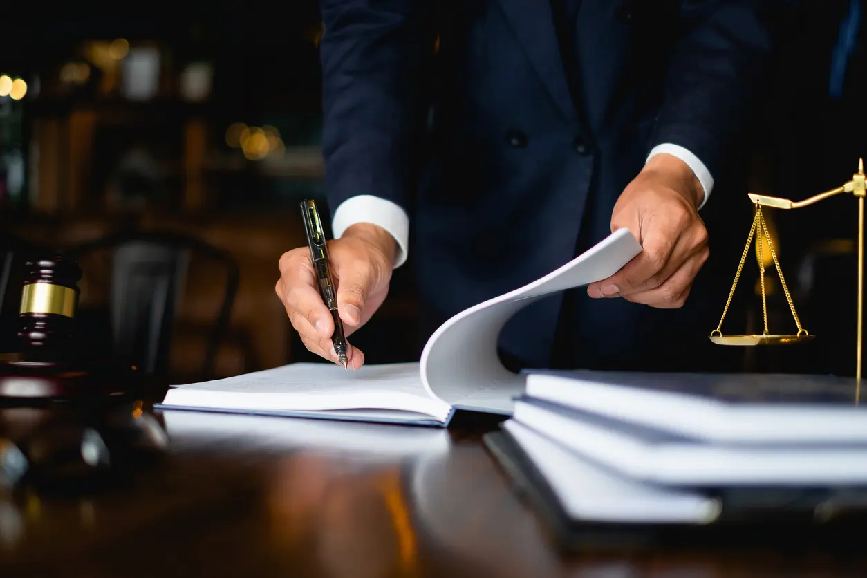 A Houston business fraud lawyer writing in a notebook.