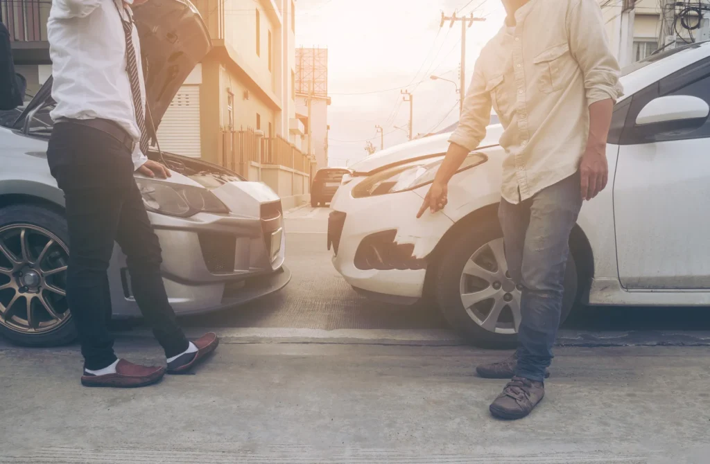Two people arguing by a car accident.