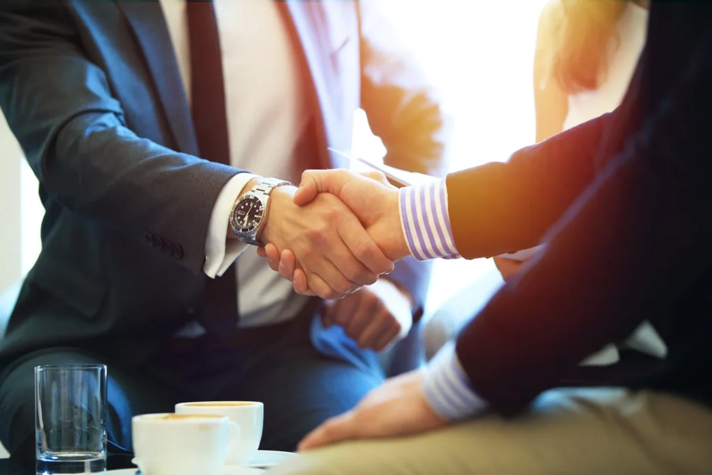 Attorney and client shaking hands.